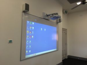 Epson EB-585W classroom projector with two Epson speakers and control panel alongside